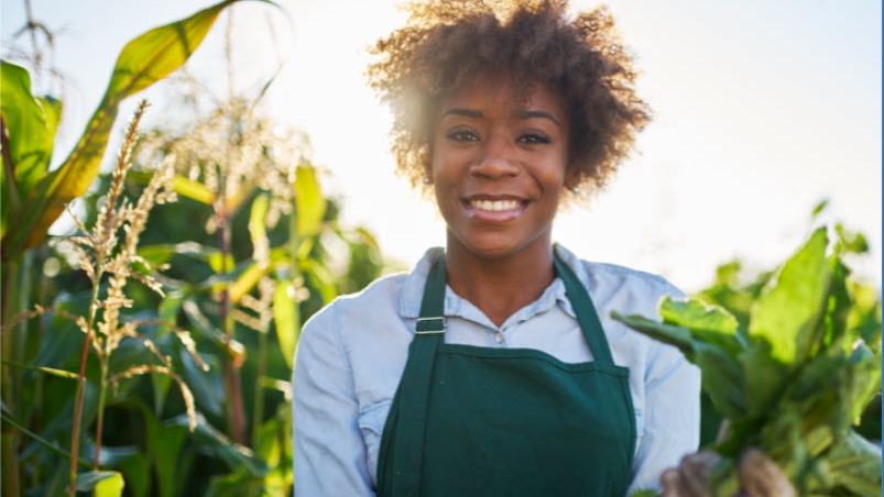 Woman standing in a corn field