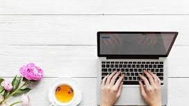 Hands shown typing on a laptop