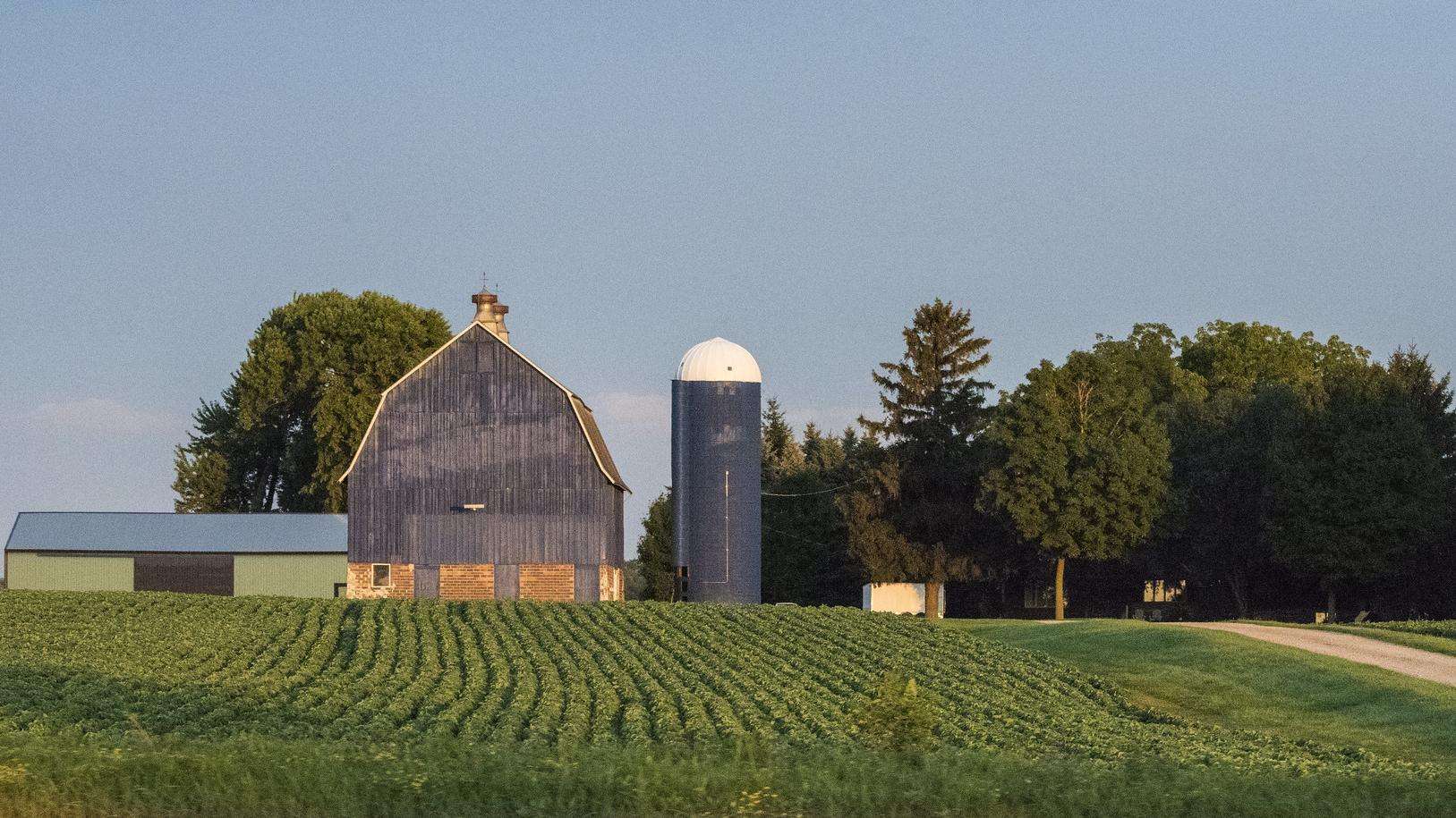 Scenic shot of a barn with fields in front.