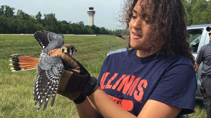 Student holding bird at University of Illinois AgDiscovery