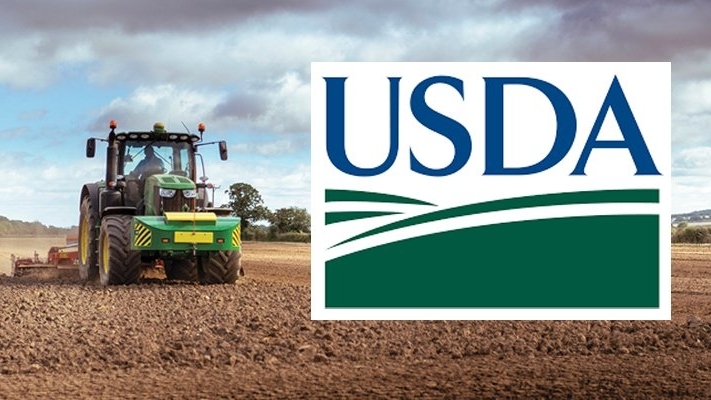 A tracktor on a farm with USDA logo