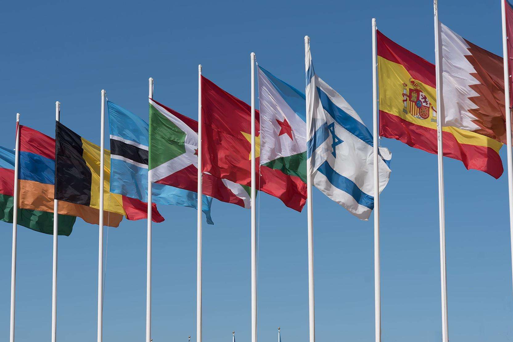 row of flags against  a blue sky