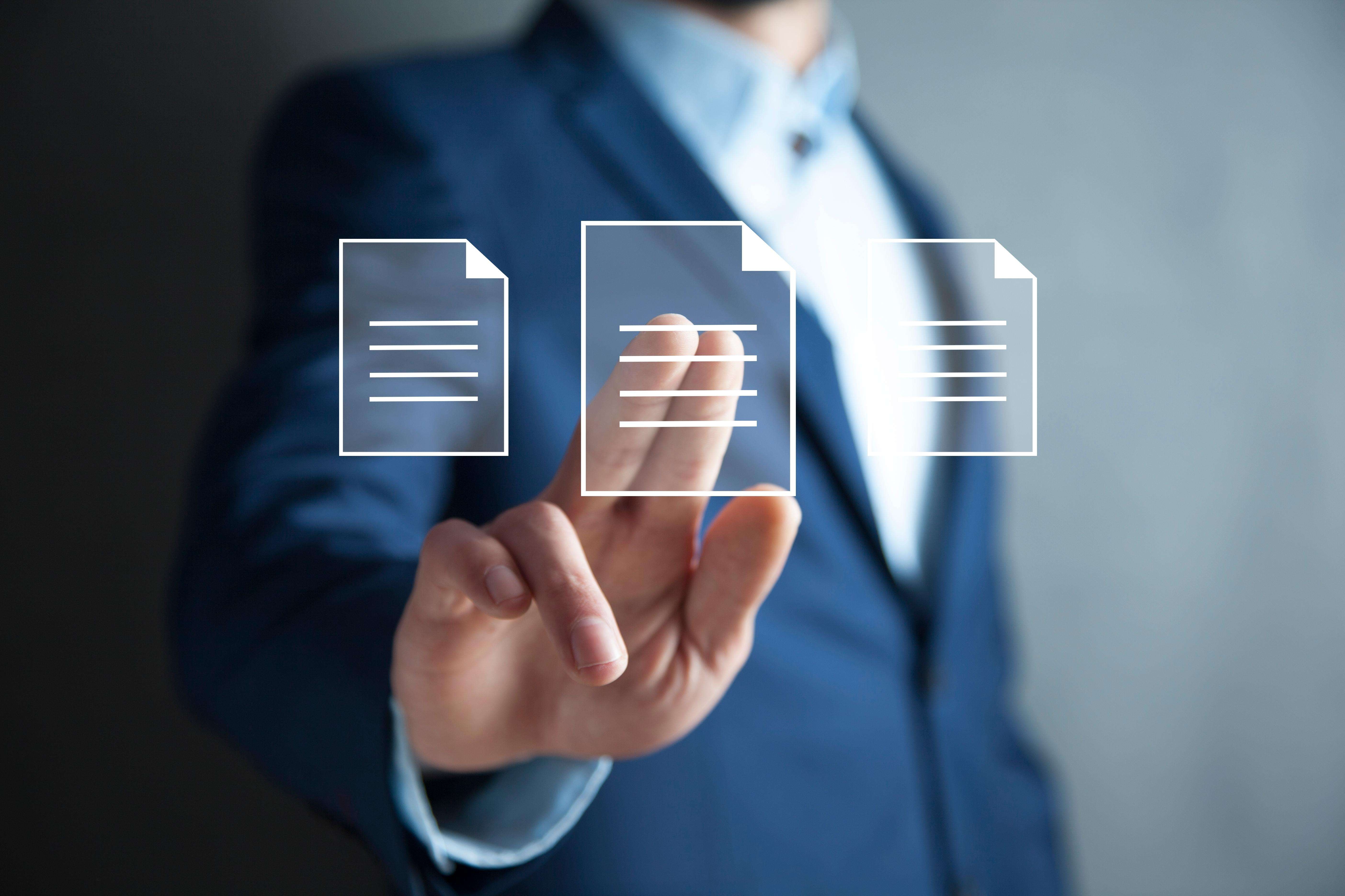 man in suit selecting electronic document