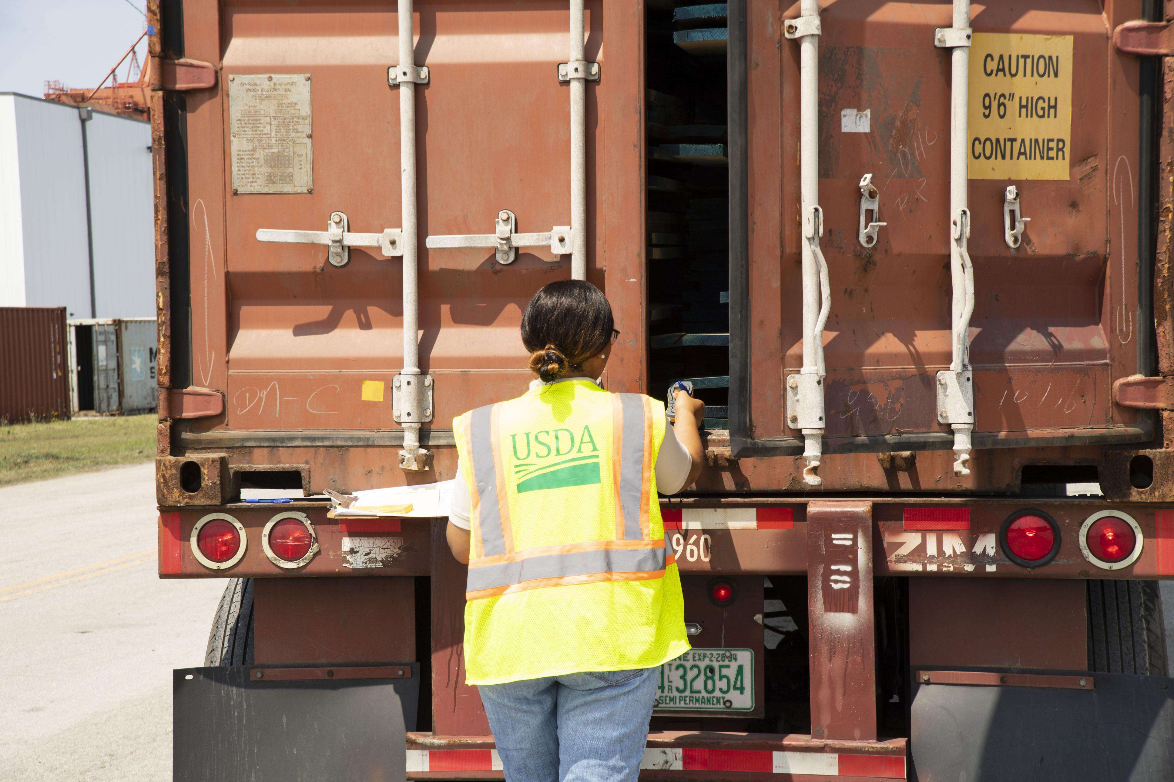 a USDA worker investigating inside of a truck