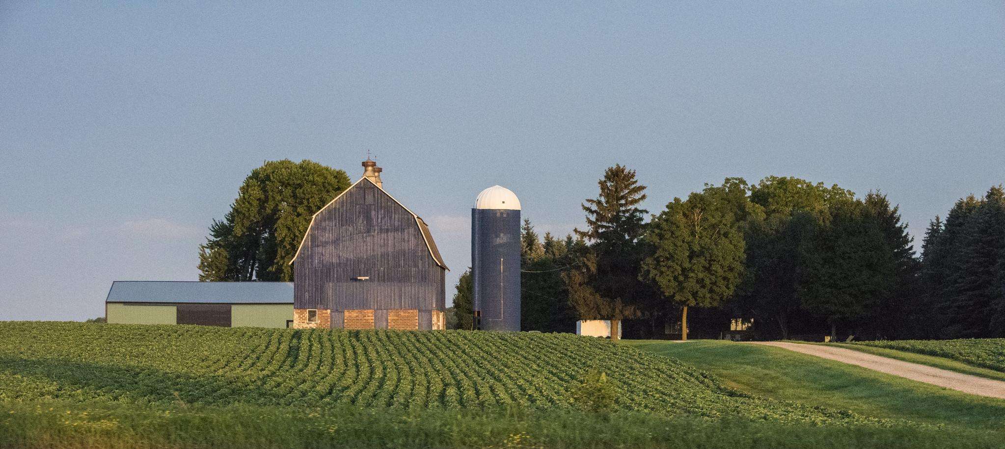 Scenic shot of a barn with fields in front.