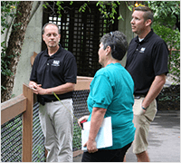 An inspector talking with zoo keepers
